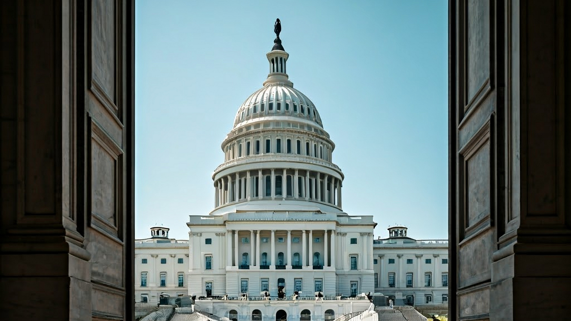 U.S. Capitol building seen through a pair of open doors