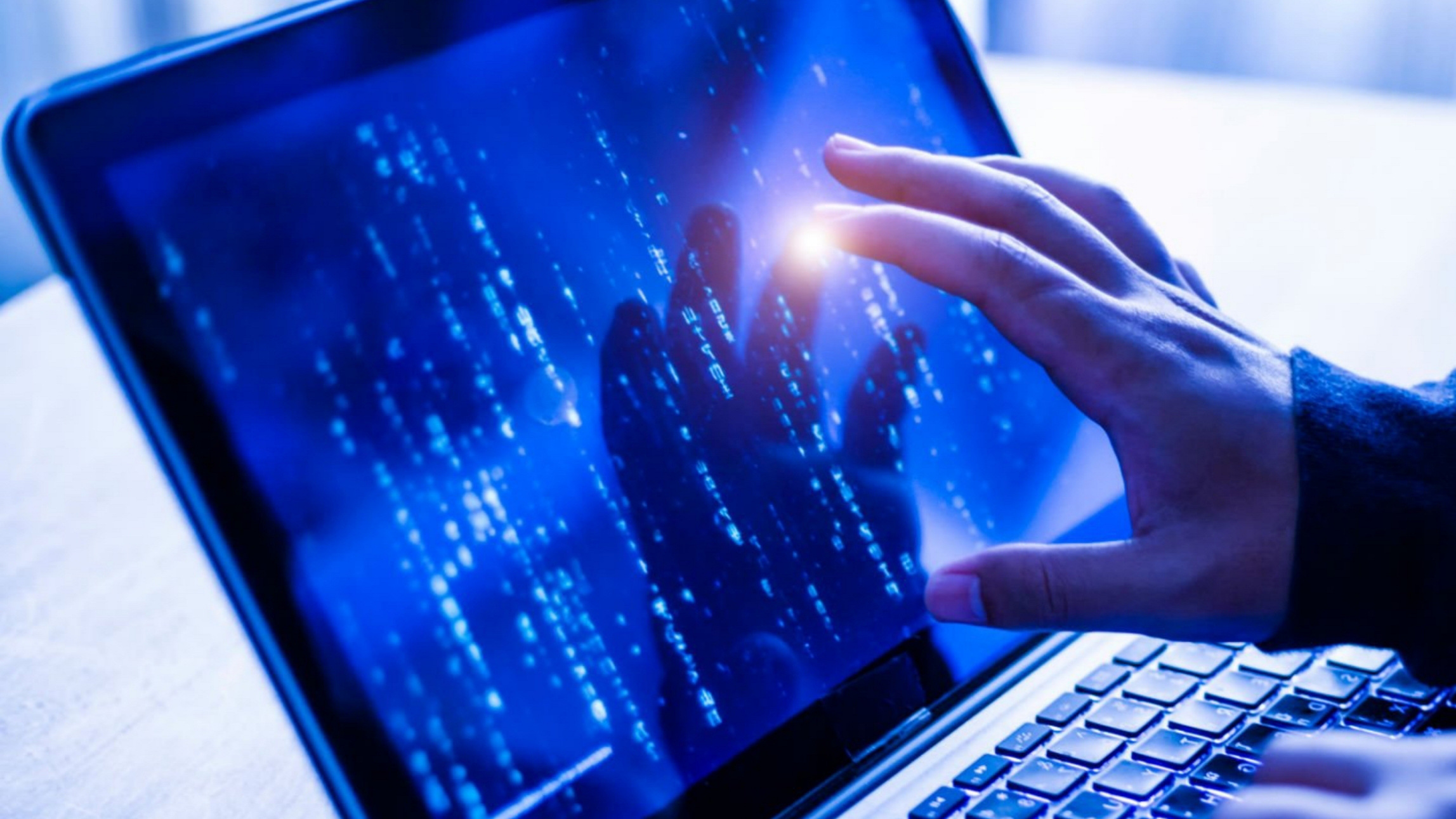 hand reaching towards computer display, hacker concept