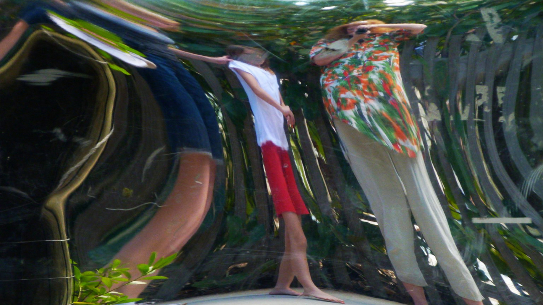 reflections of people in a distorting mirror